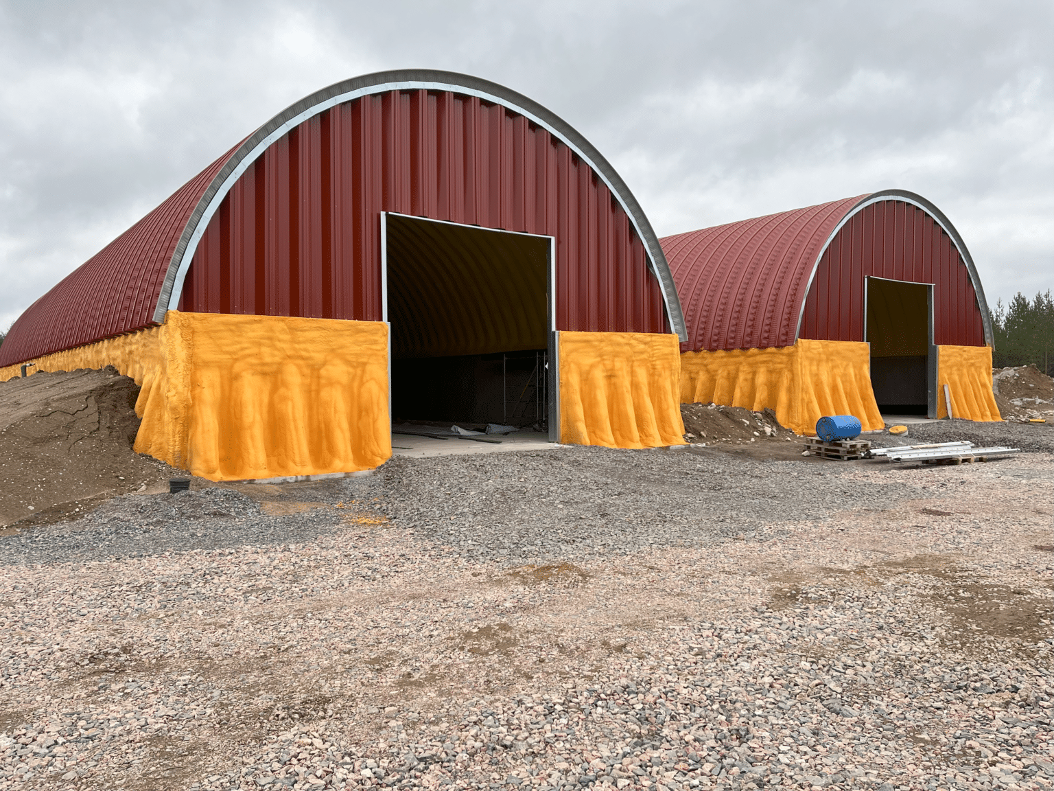 Pyhäjärven biokaasulaitoksen puna-keltaiset reaktorirakennukset pystyssä, viimeistelyä vaille valmiina.